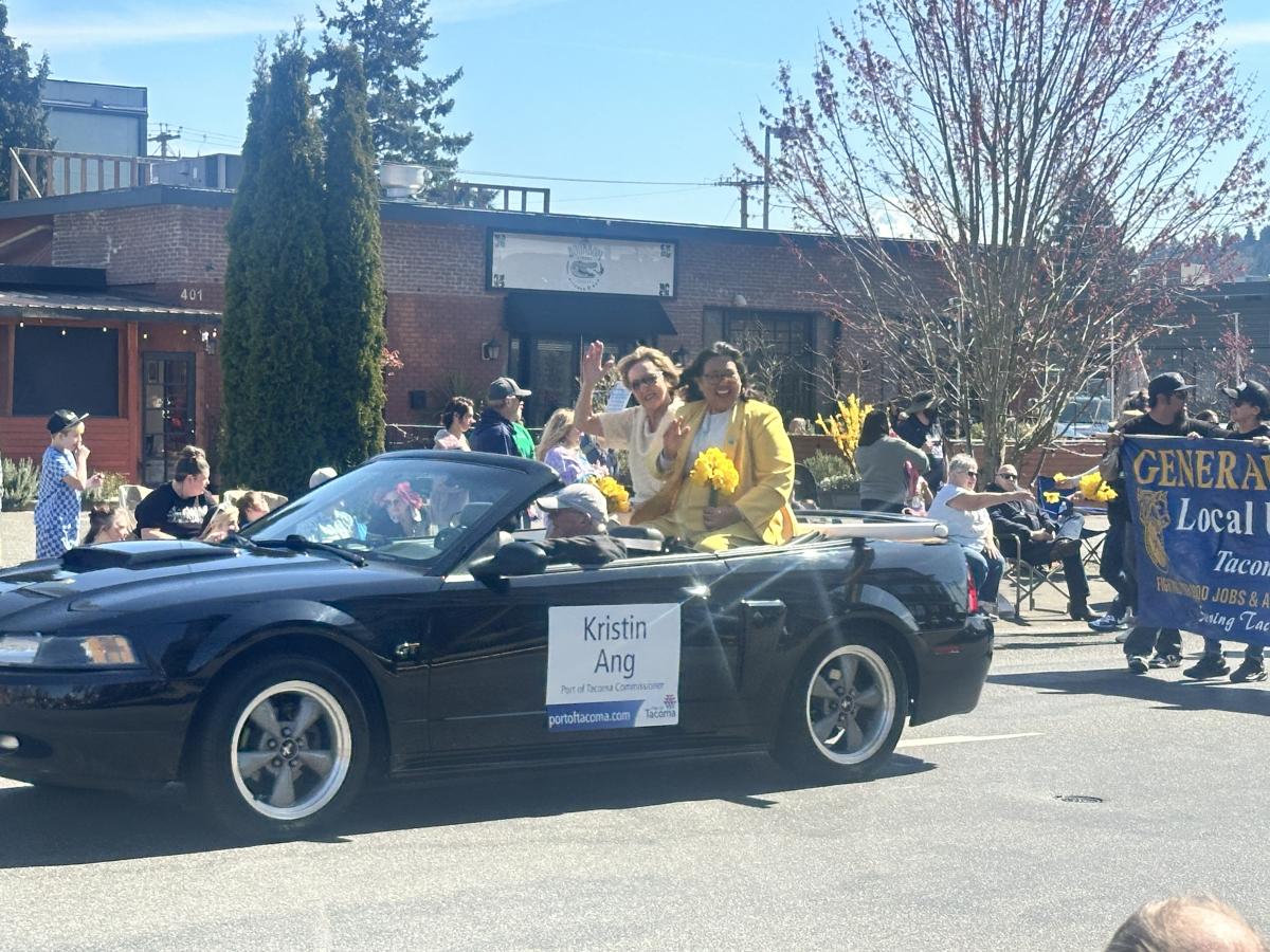 Port Commissioners Deanna Keller and Kristin Ang ride in a vehicle in the Grand Floral Daffodil Parade